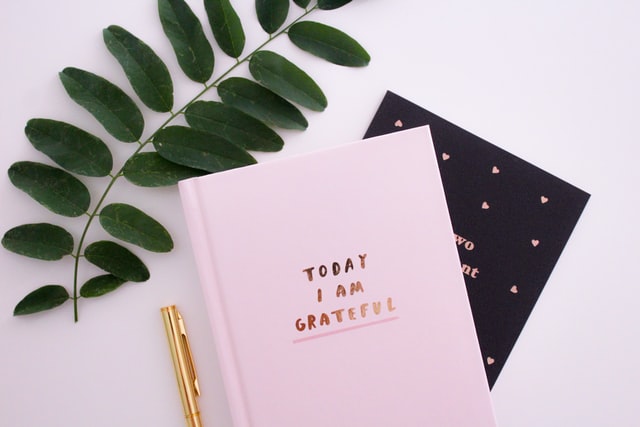 practice gratitude journaling with journal that says, "Today I am grateful"